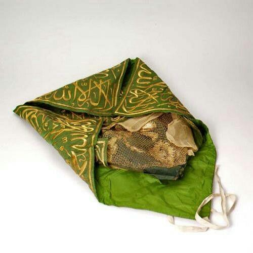 Photograph of an embroidered green relic garment/cloth.